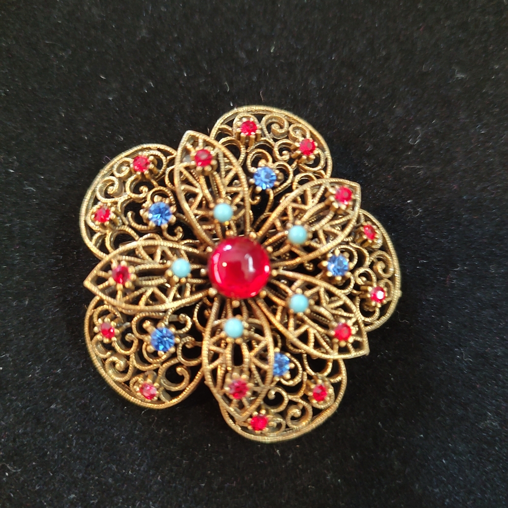 Elegant Gold Filigree Brooch with Red and Blue Accents